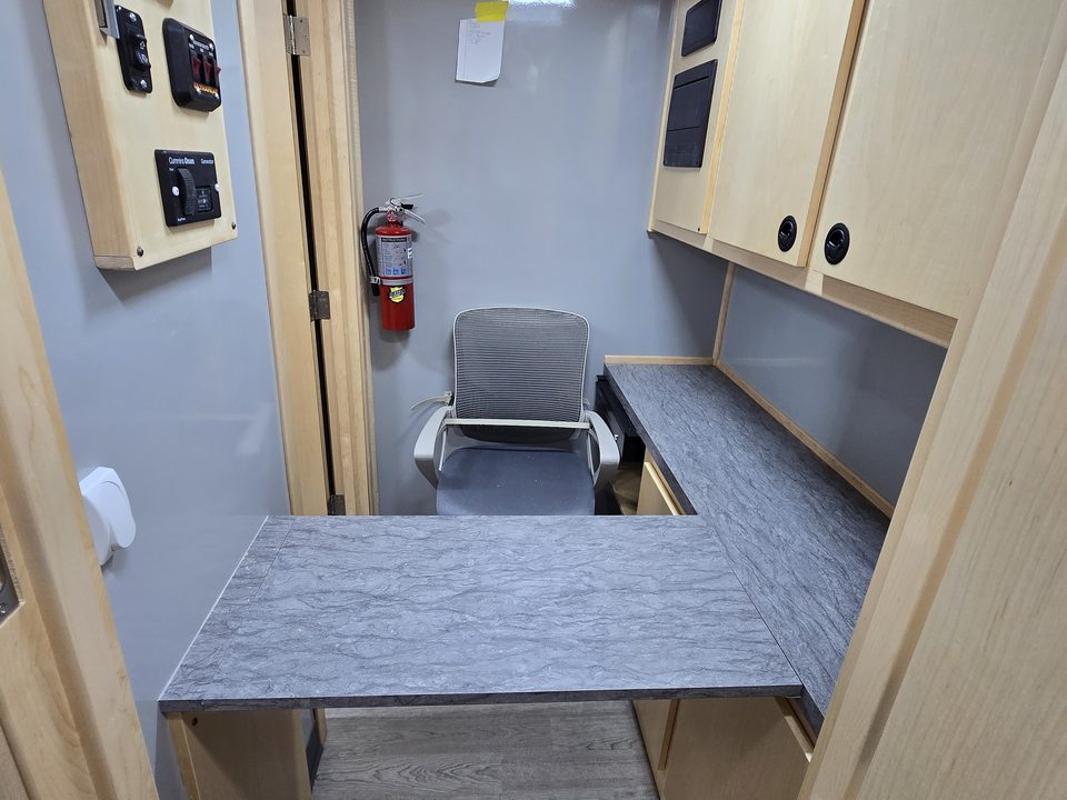 Intake booth with counter, cabinets and chair