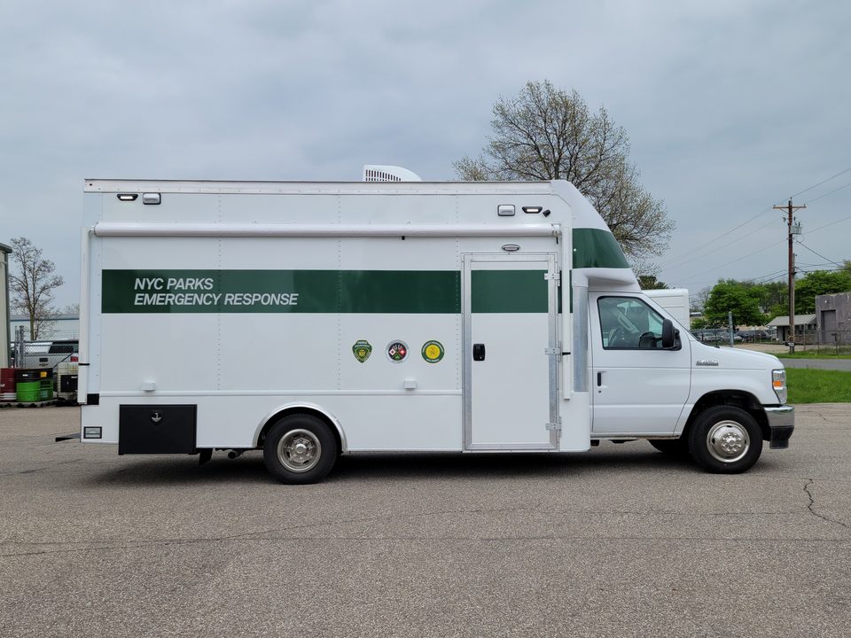 Emergency response unit on a Ford E-450 cutaway, white with a green NYC Parks Emergency Response band, passenger side