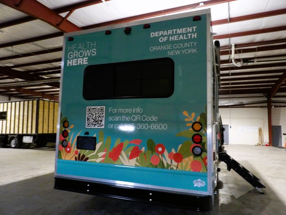 Mobile health unit, rear, wrapped with a QR code