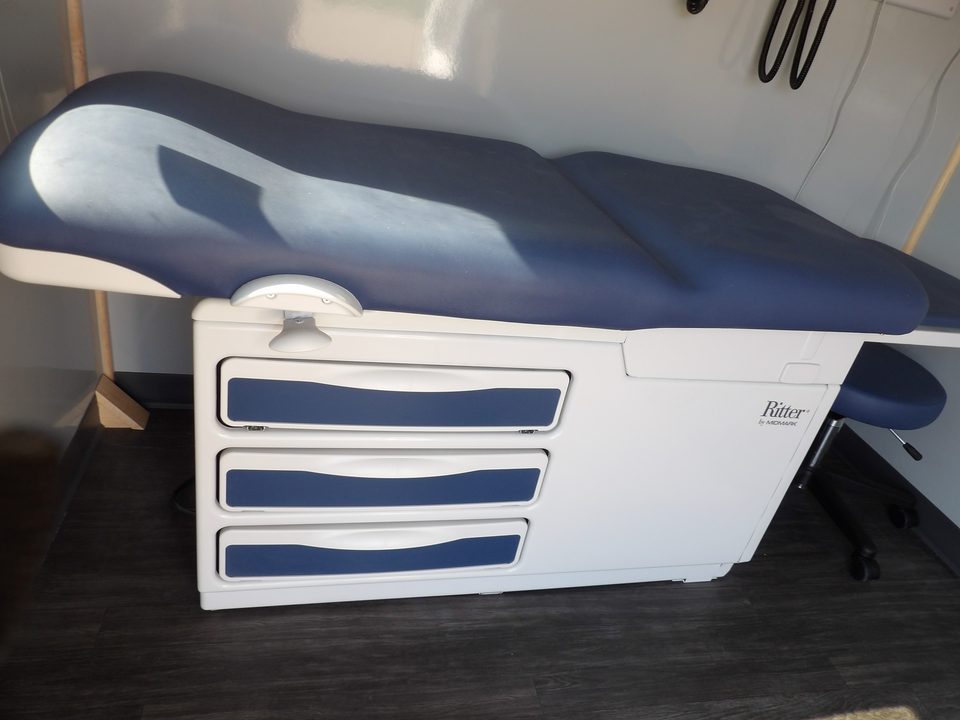 Exam table with blue upholstery