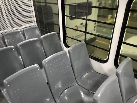 Prisoner transport interior: molded seats, mesh partition
