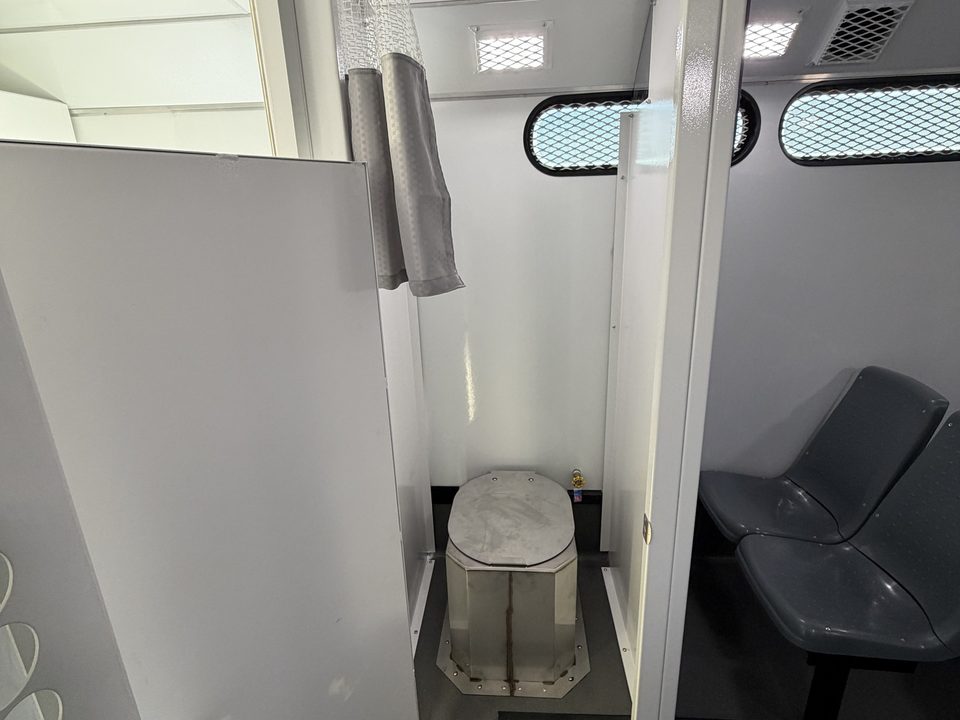 Prisoner transport secure restroom compartment
