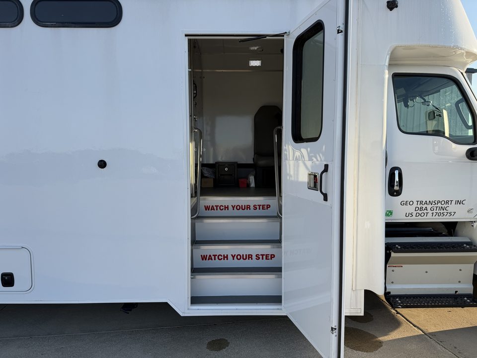 Prisoner transport entry door open, steps marked watch your step