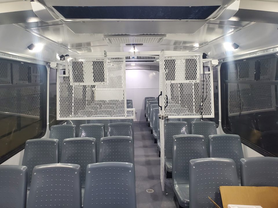 Prisoner transport officer station with monitors