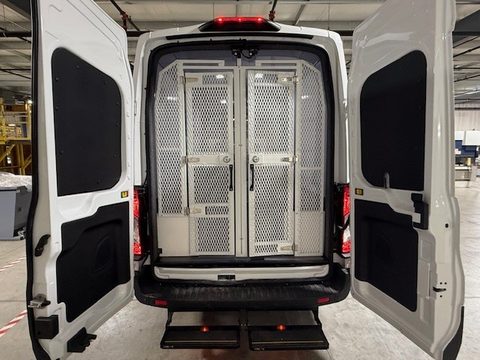 Ford Transit prisoner transport, rear doors open showing the mesh cage