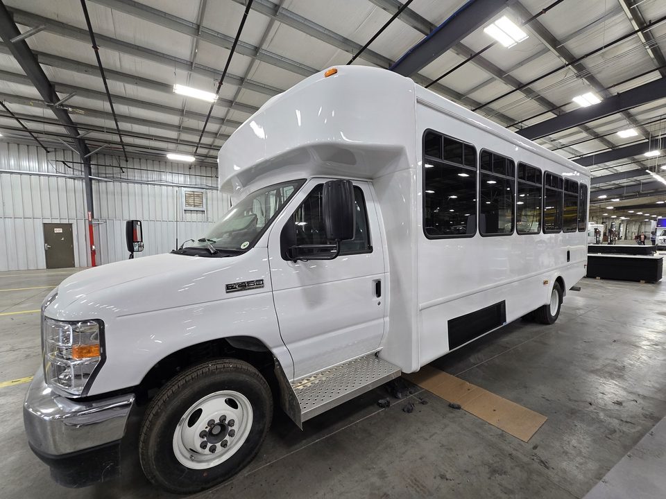 White mobile office on a Ford E-450 cutaway, front three-quarter, in the HLE plant