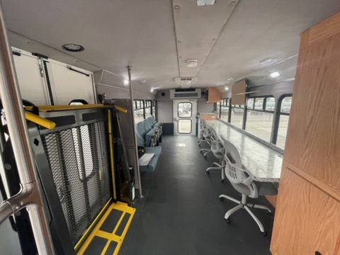 Interior looking aft: wheelchair lift, workstations along the windows