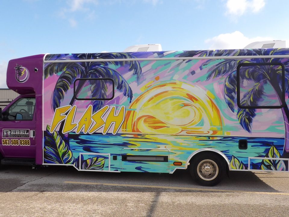 Mobile health unit, driver side, purple and teal FLASH wrap, blue sky