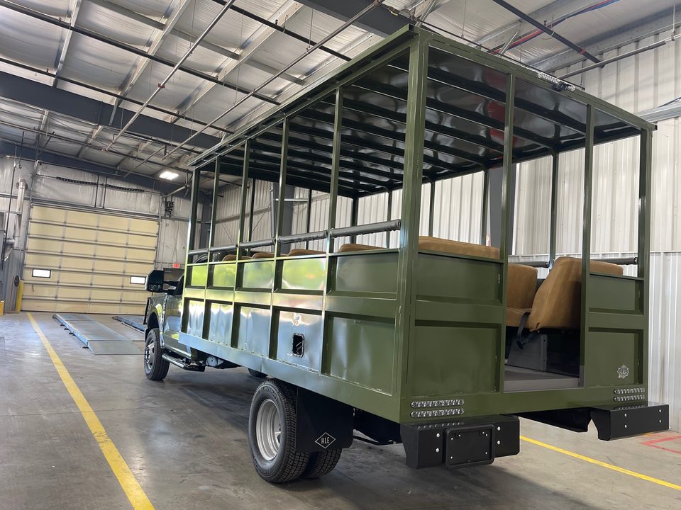 Safari truck, rear three-quarter, bench seats visible