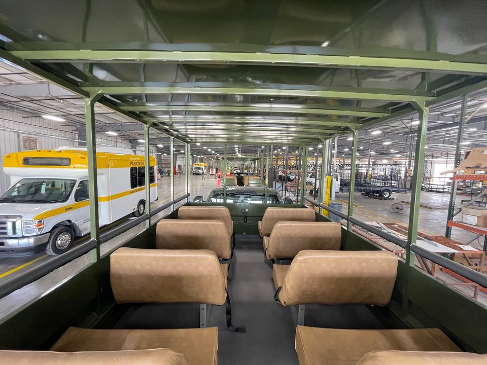 Tan bench seats inside the open cage body