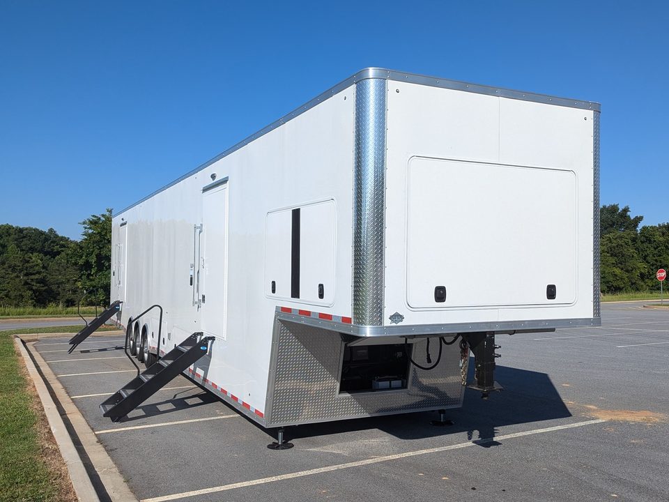 White gooseneck lab trailer outside, front three-quarter