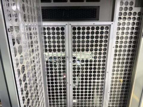 Perforated-steel cell doors in the aisle