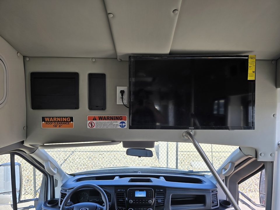 Wall monitor mounted above the cab opening