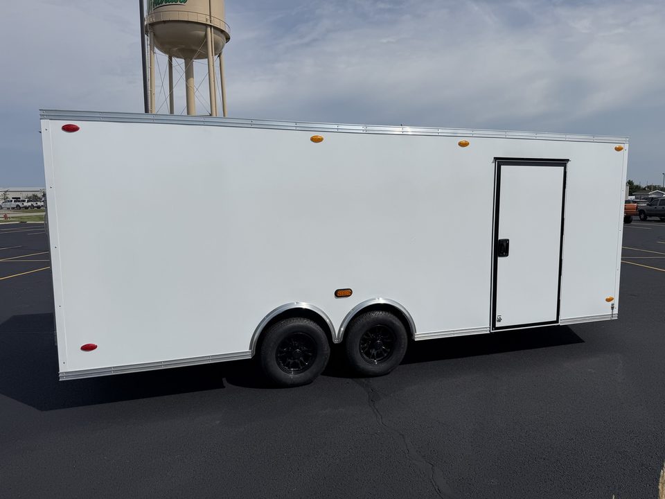 Enclosed trailer, side, with the Wakarusa water tower behind