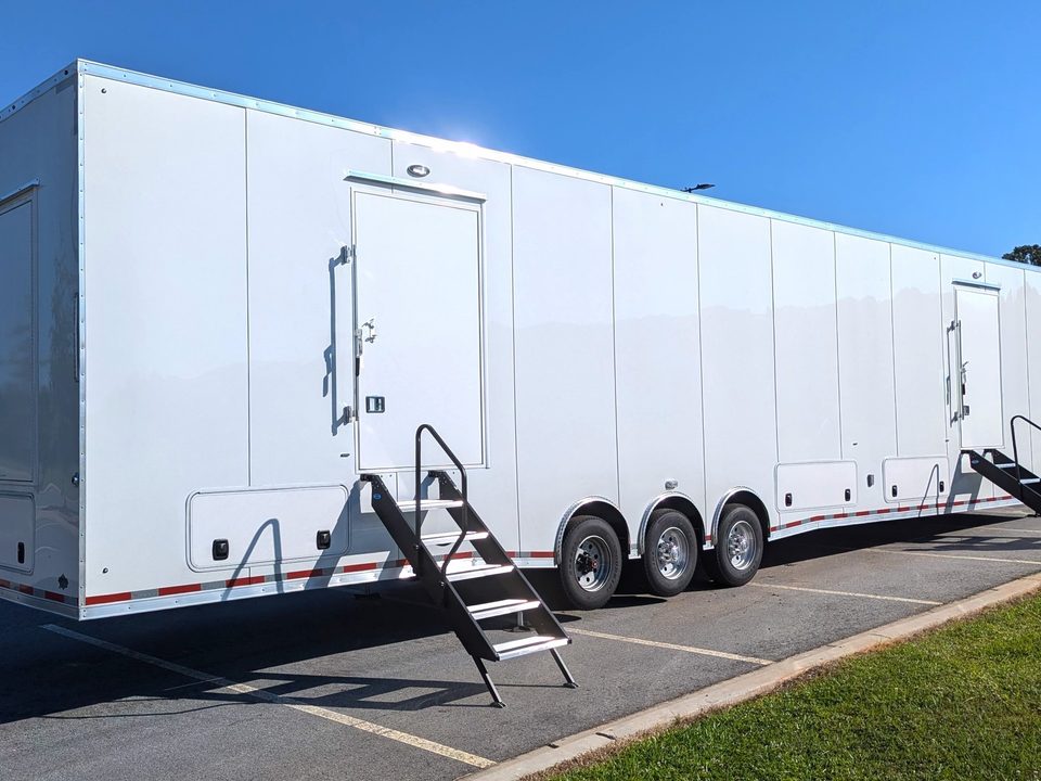 White gooseneck trailer, side, entry steps