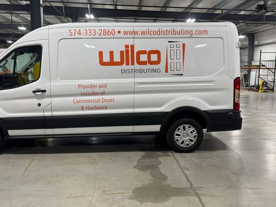 Ford Transit van upfit, white with company lettering, in the HLE plant