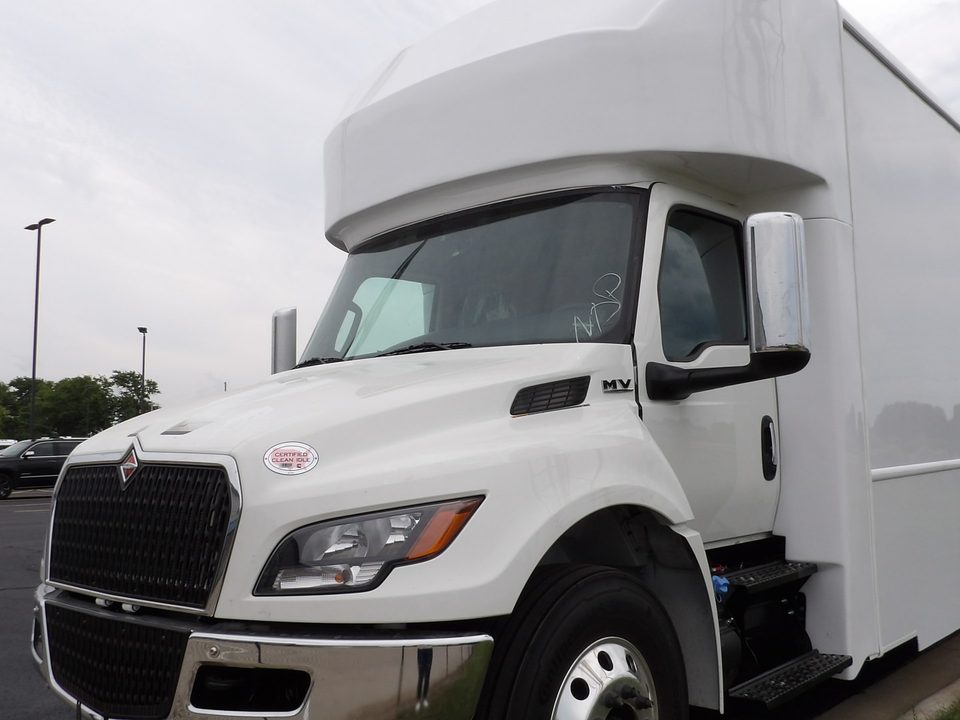 White mammography unit body on an International MV, front three-quarter, outside the HLE plant