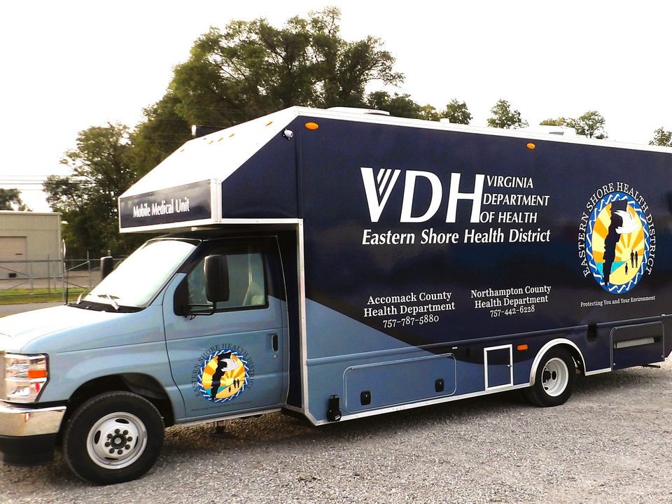 Mobile medical unit on a Ford E-Series cutaway, wrapped, front three-quarter