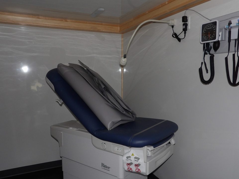 Exam table with diagnostic set on the wall