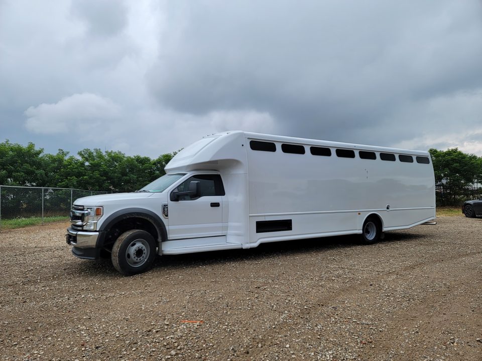 White prisoner transport bus on a Ford Super Duty chassis, front three-quarter, outside