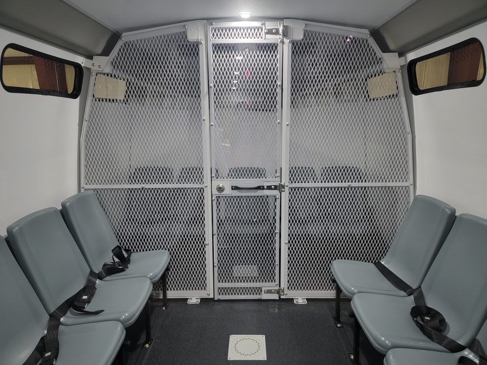 Mesh security partition and door between seating compartments