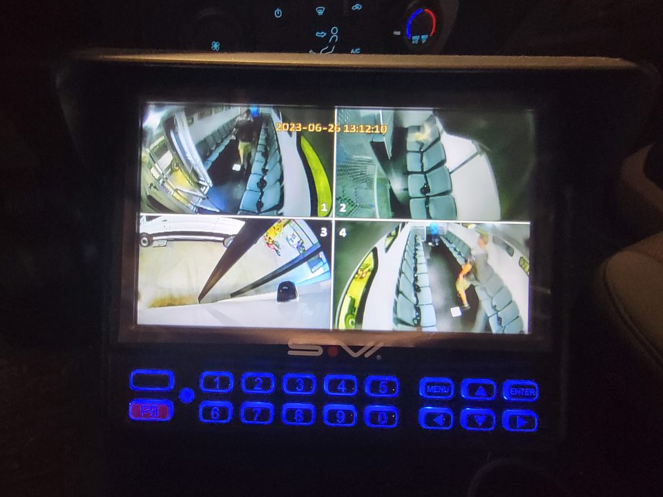 Four-camera monitor in the cab showing the compartments