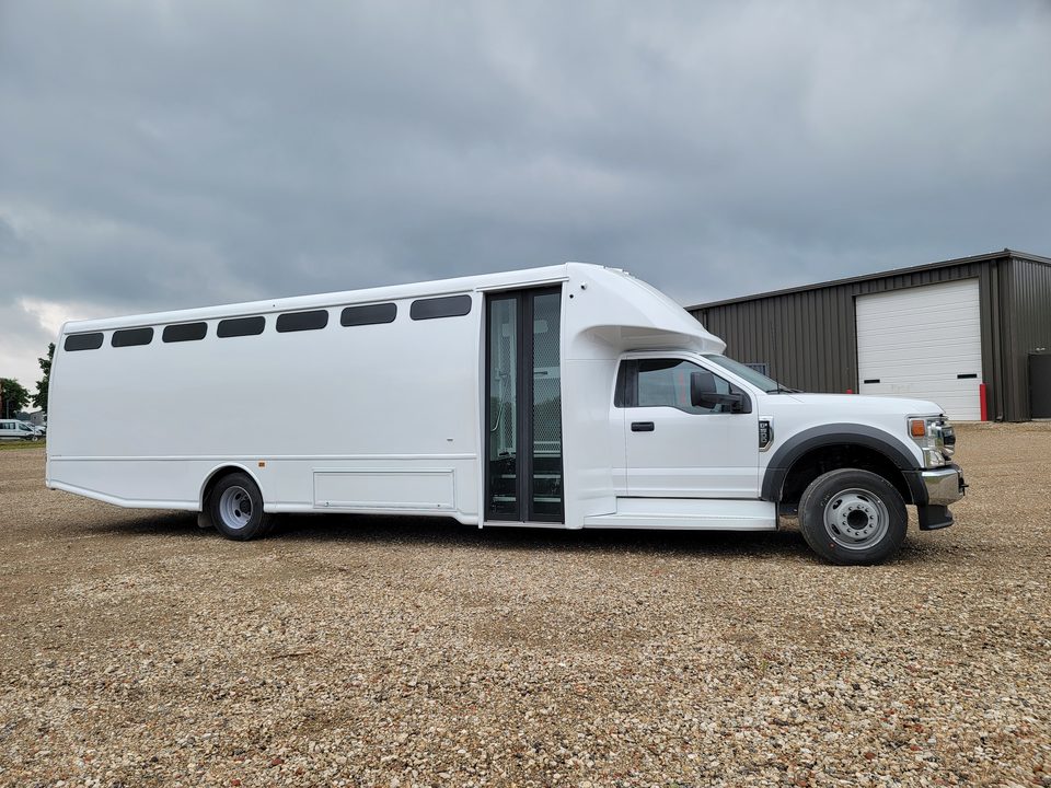 Prisoner transport bus, passenger side, entry door and slot windows