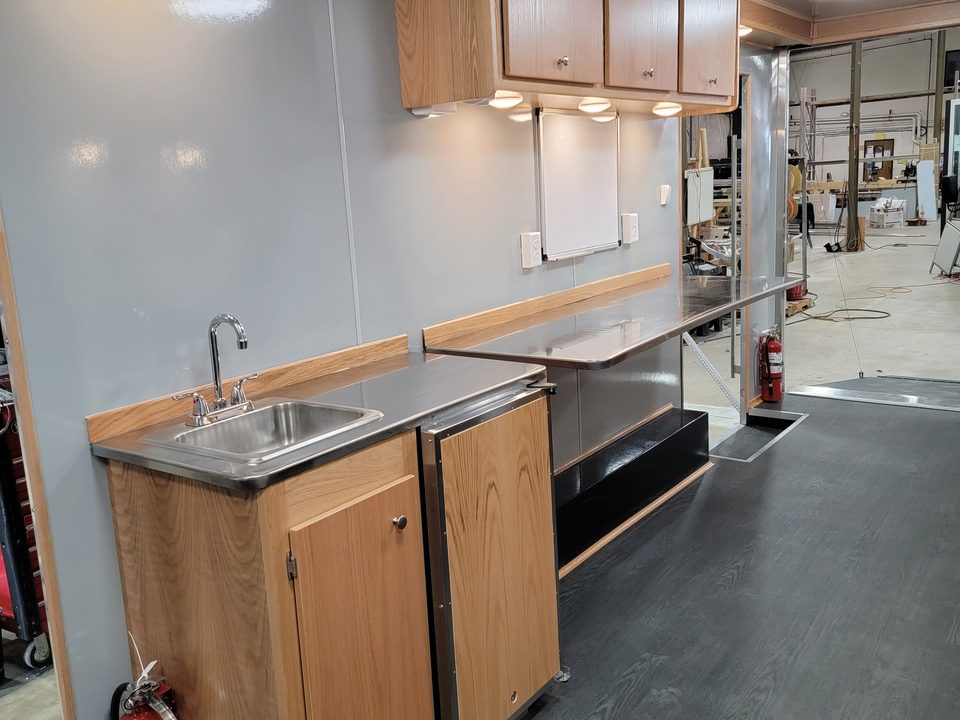 Sink counter and cabinets inside the trailer