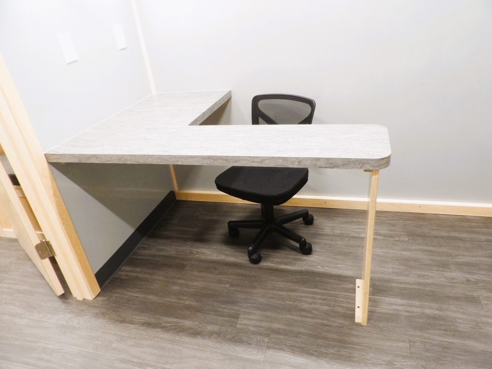 L-shaped desk and task chair inside the mobile clinic