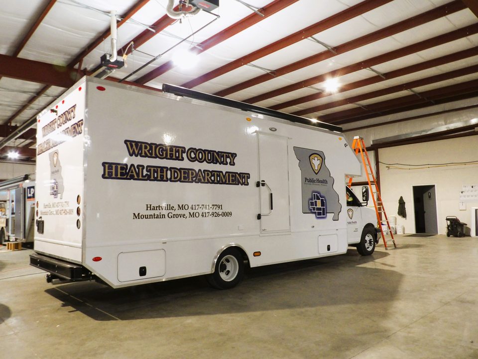 Mobile clinic, rear three-quarter, wrapped